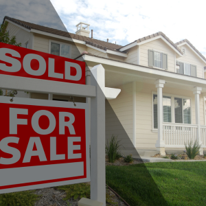 Sold sign over a For Sale sign in front of a suburban home, representing how a better strategy can help sell a home that didn’t sell the first time.