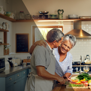 Senior couple smiling and preparing a meal together in a bright, modern kitchen.